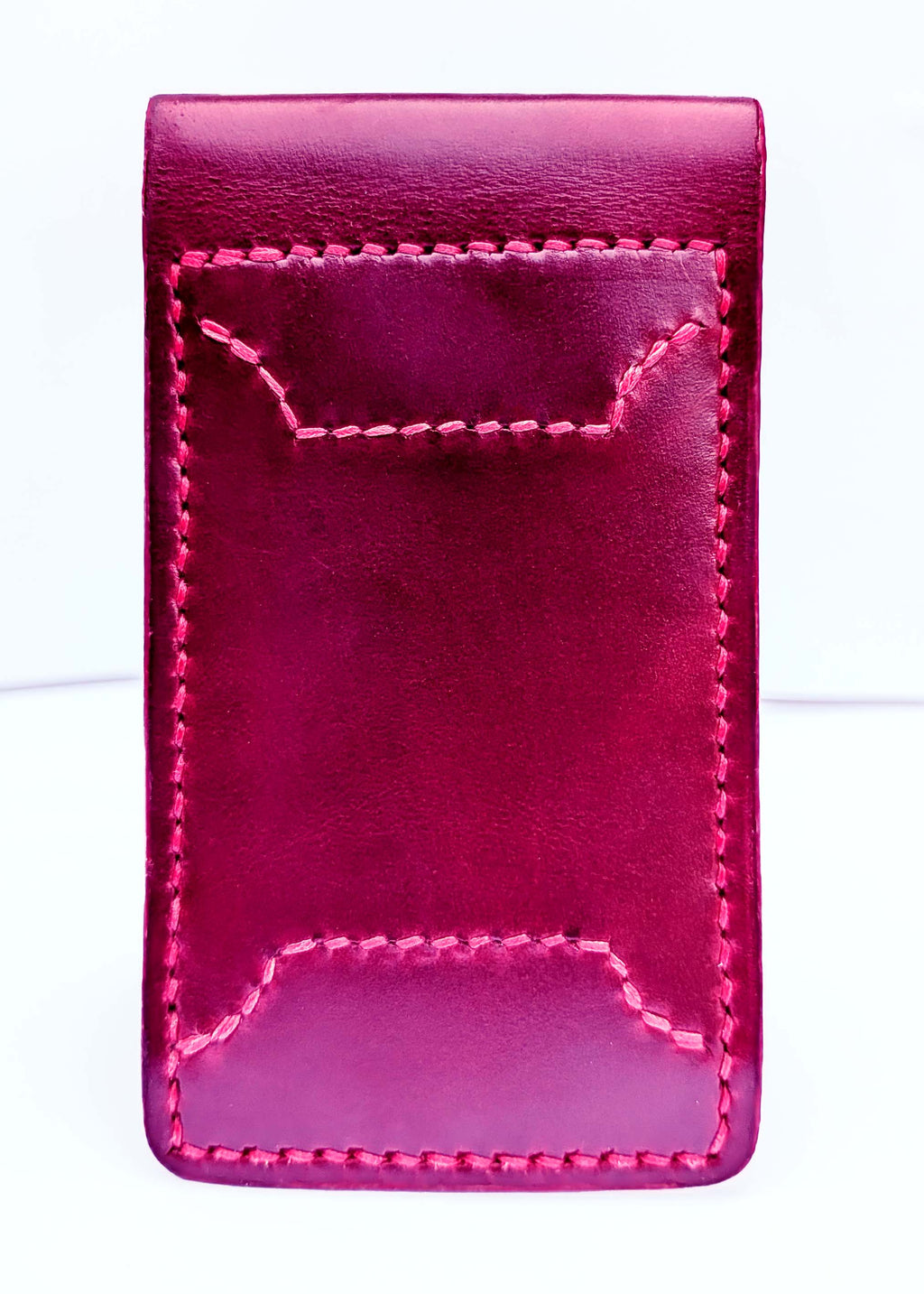 A deep red leather bifold money clip wallet with decorative red contrast stitching, shown against a plain white background.